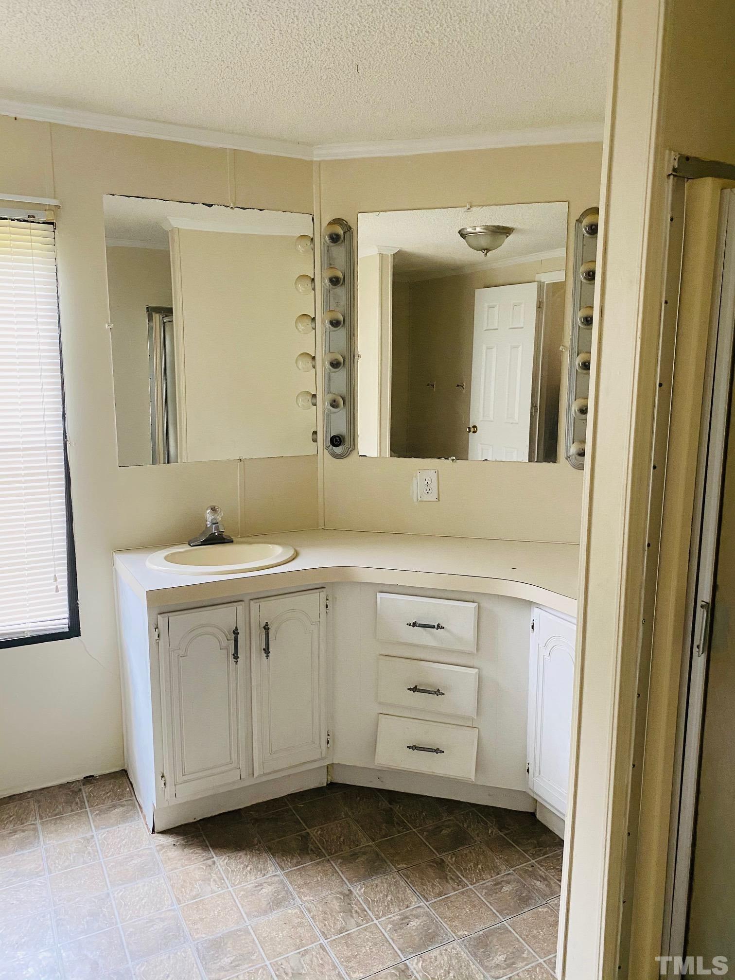 3288 Walters Road Creedmoor, NC 27522 - Photo 12 of 15 a bathroom with a sink and a mirror