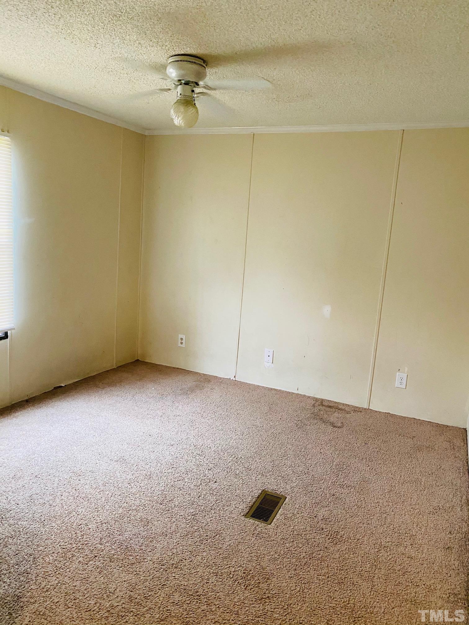 3288 Walters Road Creedmoor, NC 27522 - Photo 15 of 15 an empty room with a ceiling fan
