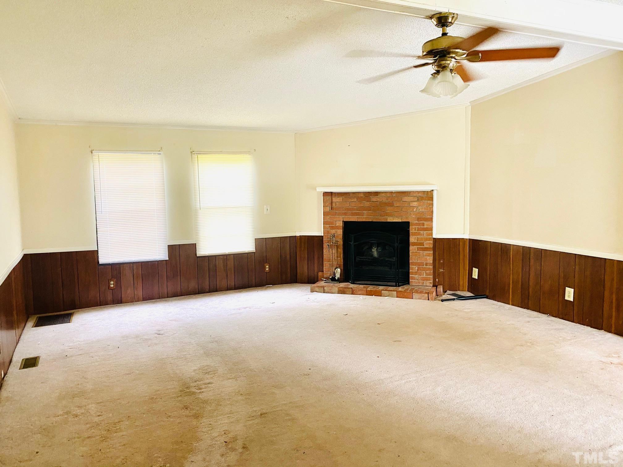 3288 Walters Road Creedmoor, NC 27522 - Photo 4 of 15 a view of empty room with fireplace and fan