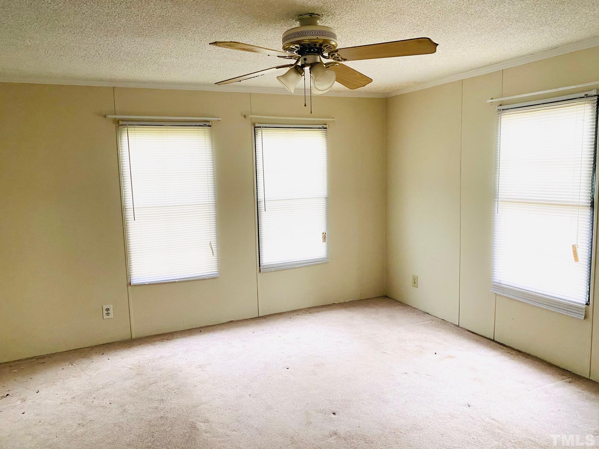 3288 Walters Road Creedmoor, NC 27522 - Photo 10 of 15 an empty room with a window and a ceiling fan
