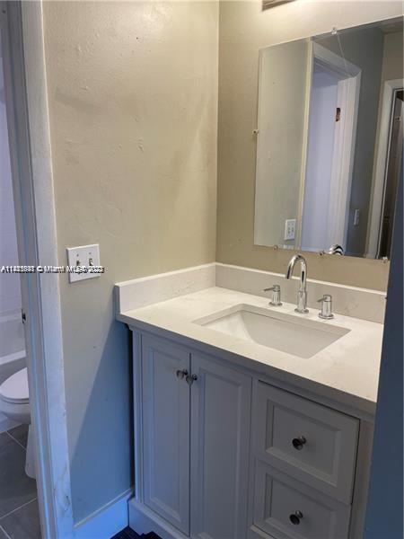 4481 West McNab Road, Unit 25 Pompano Beach, FL 33069 - Photo 4 of 5 a bathroom with a sink and a mirror