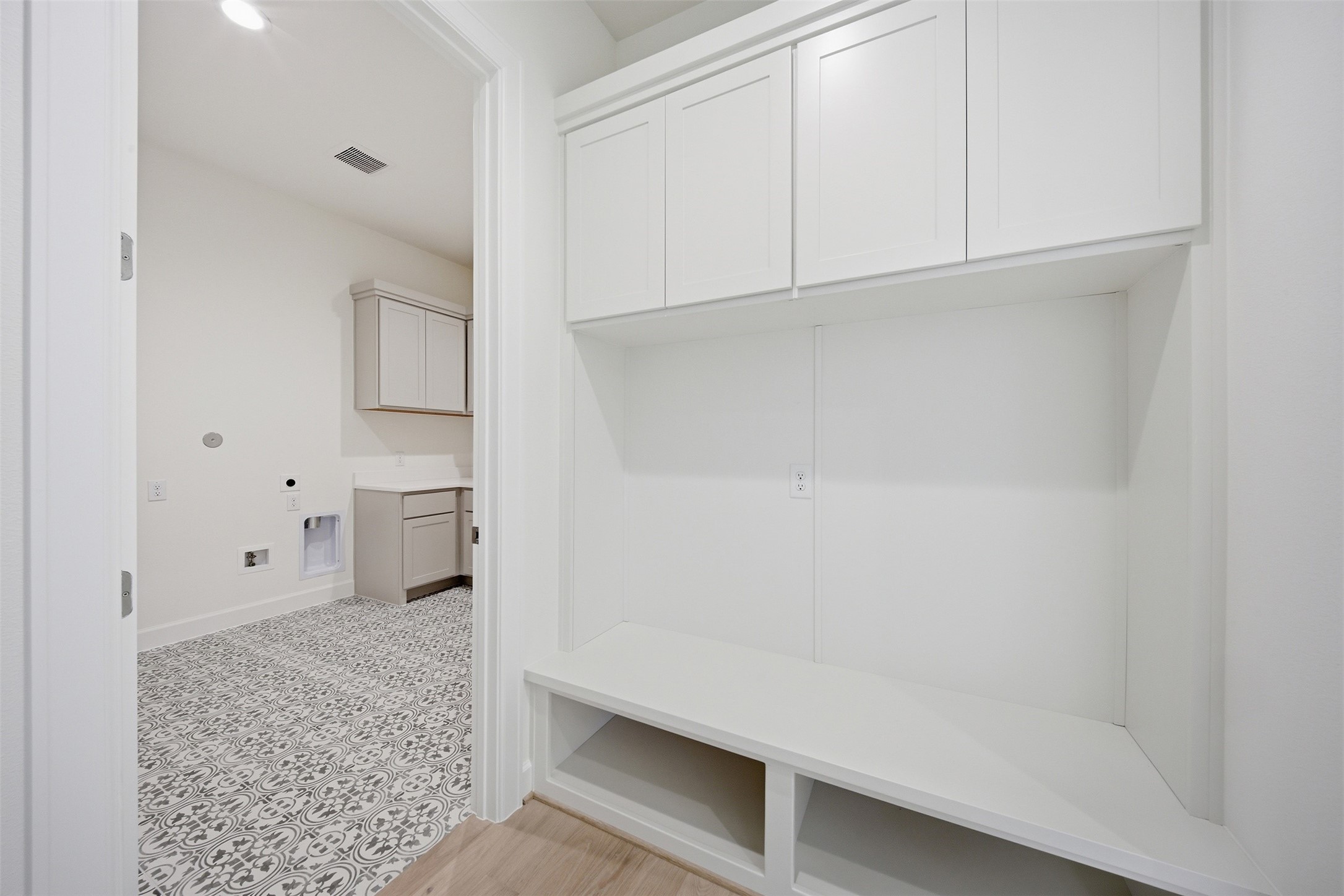 416 Venado View Court Conroe, TX 77304 - Photo 23 of 34 Functional and stylish mudroom with built-in storage conveniently located adjacent to the spacious utility room with designer tile flooring and additional cabinetry.
