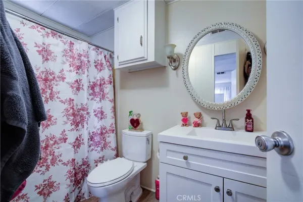 a bathroom with a sink toilet and a mirror