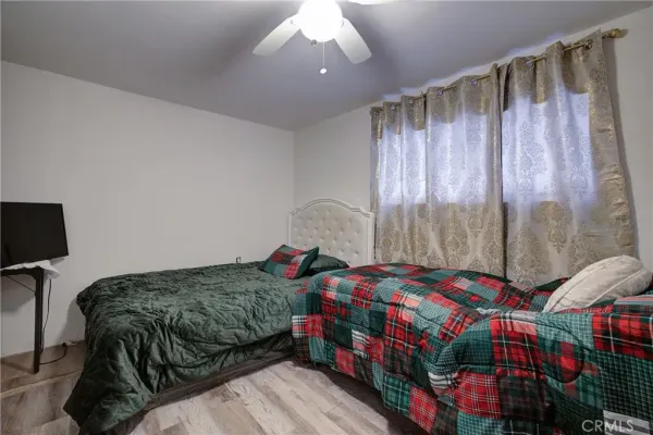 a bedroom with a bed a window and a mirror