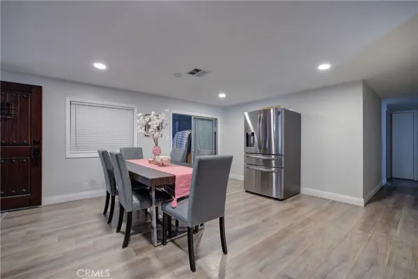 a dining room with furniture and wooden floor