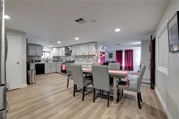 a view of a dining room with furniture and wooden floor
