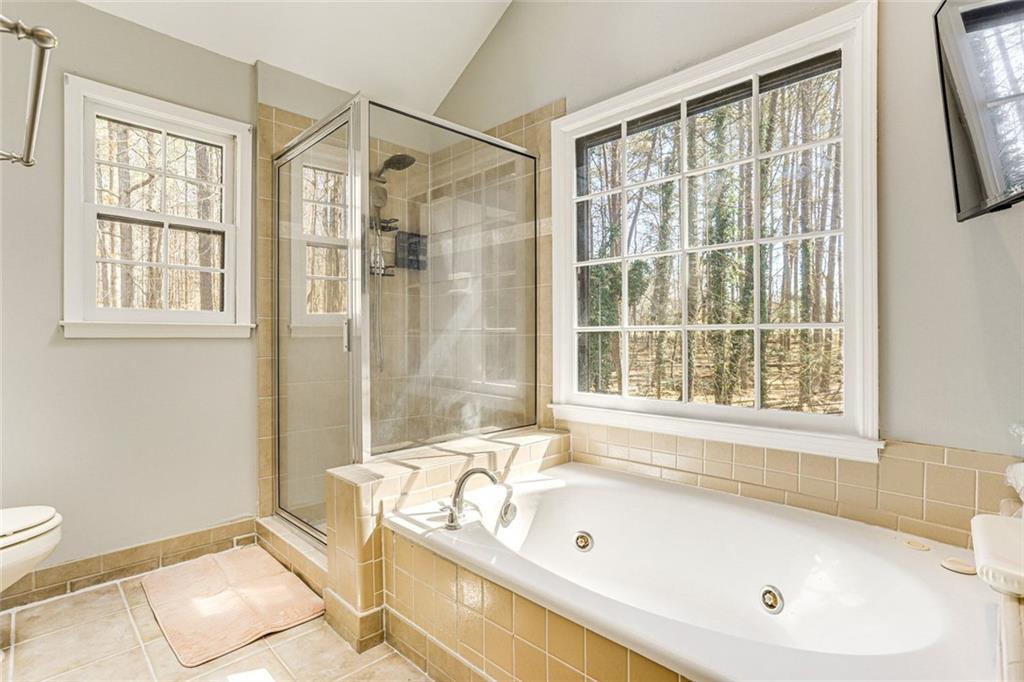3595 Chastain Court Alpharetta, GA 30004 - Photo 11 of 13 a bathroom with a tub a sink and a window