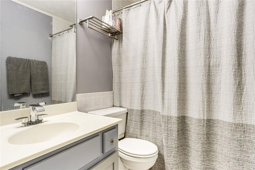 3595 Chastain Court Alpharetta, GA 30004 - Photo 6 of 13 a bathroom with a sink toilet and shower