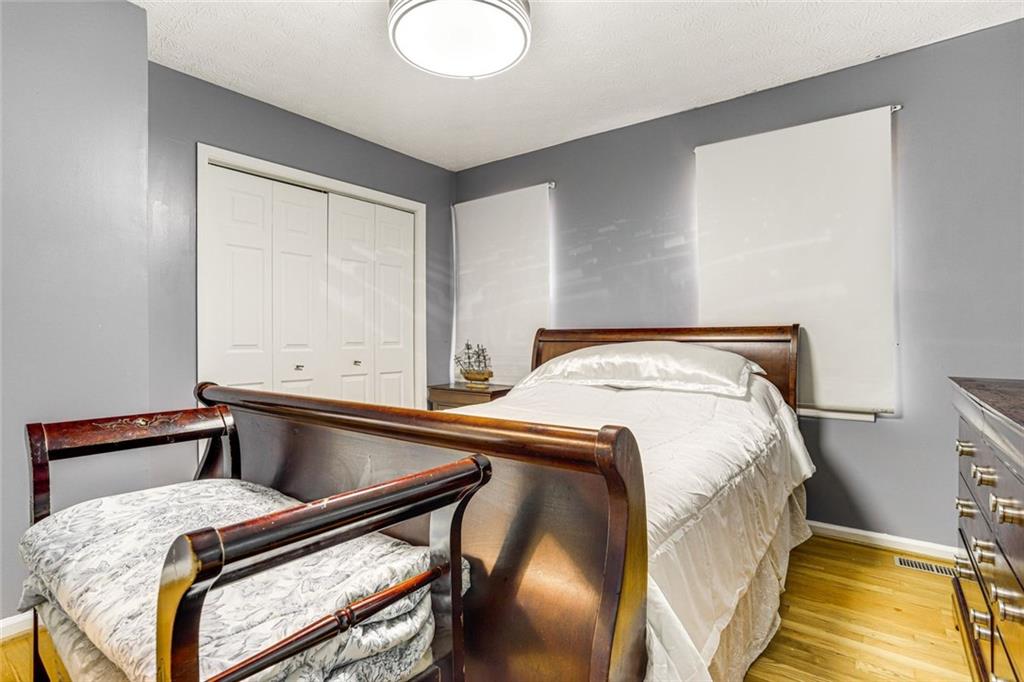 3595 Chastain Court Alpharetta, GA 30004 - Photo 7 of 13 a bed sitting in a bedroom next to a window