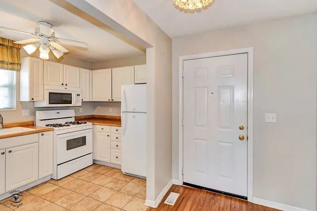 a utility room with closet and mirror