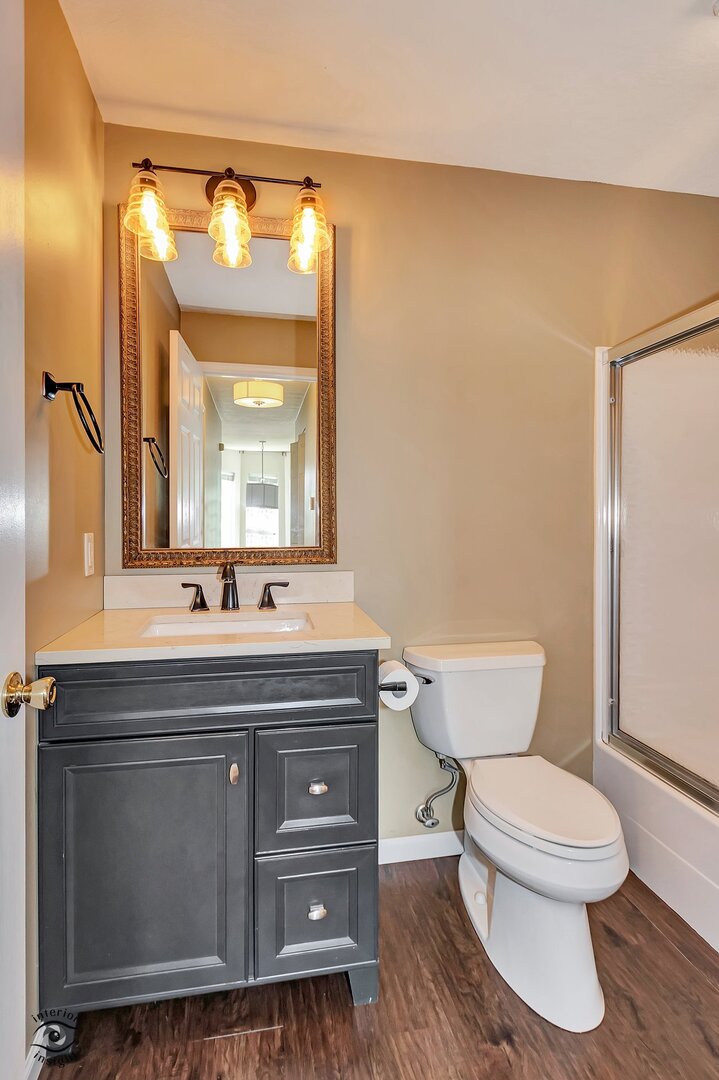 608 Huntington Court, Unit 608 Bourbonnais, IL 60914 - Photo 18 of 27 a bathroom with a toilet a sink and mirror