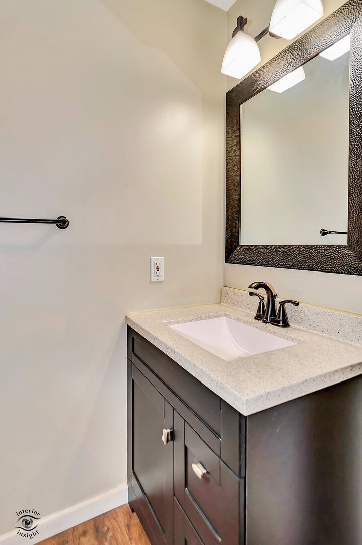 608 Huntington Court, Unit 608 Bourbonnais, IL 60914 - Photo 23 of 27 a bathroom with a sink and a mirror
