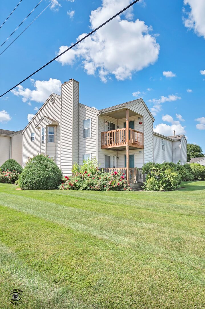 608 Huntington Court, Unit 608 Bourbonnais, IL 60914 - Photo 25 of 27 a front view of a house with garden