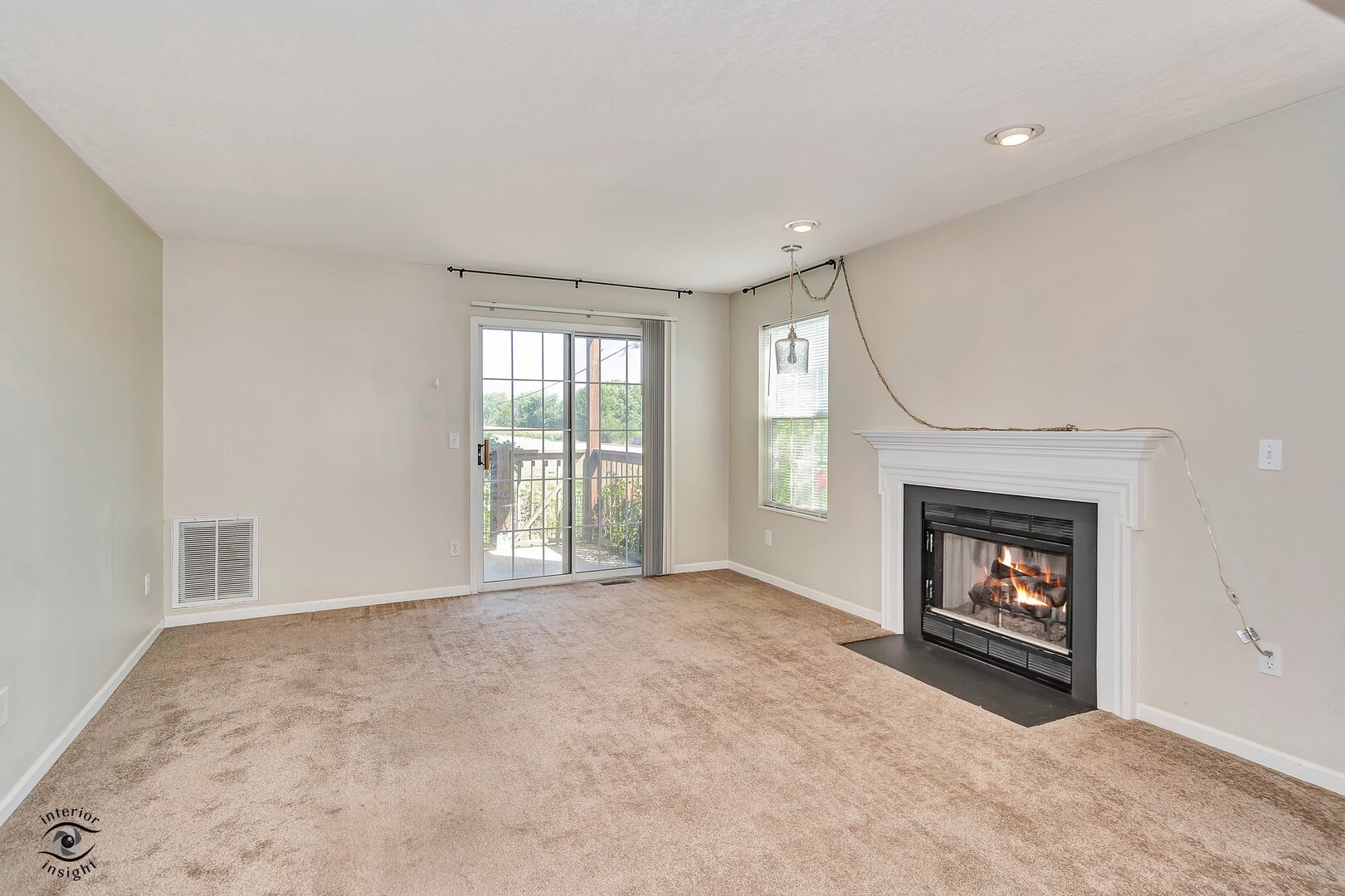 608 Huntington Court, Unit 608 Bourbonnais, IL 60914 - Photo 6 of 27 a view of an empty room with a fireplace and a window