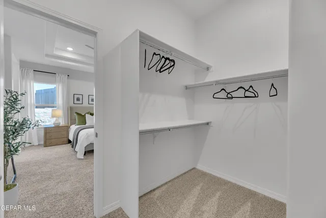 a spacious bedroom with a bed and a window