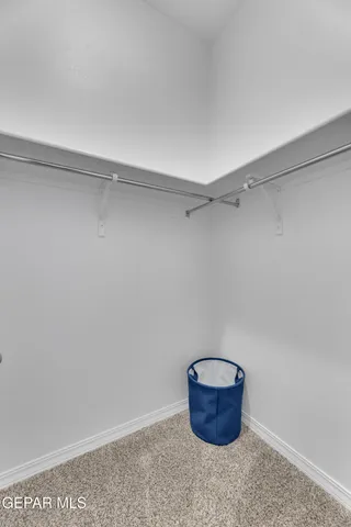 a spacious bedroom with a balcony a bed and a potted plant