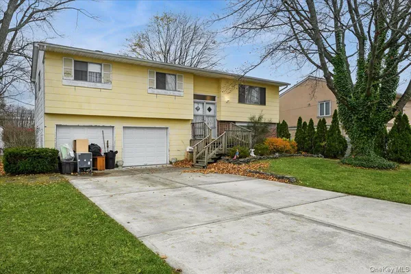 a front view of a house with a yard and garage