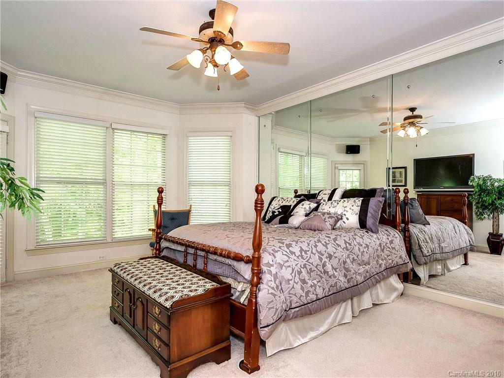 10622 Back Ridge Road Charlotte, NC 28277 - Photo 13 of 24 a bedroom with a bed and a chandelier