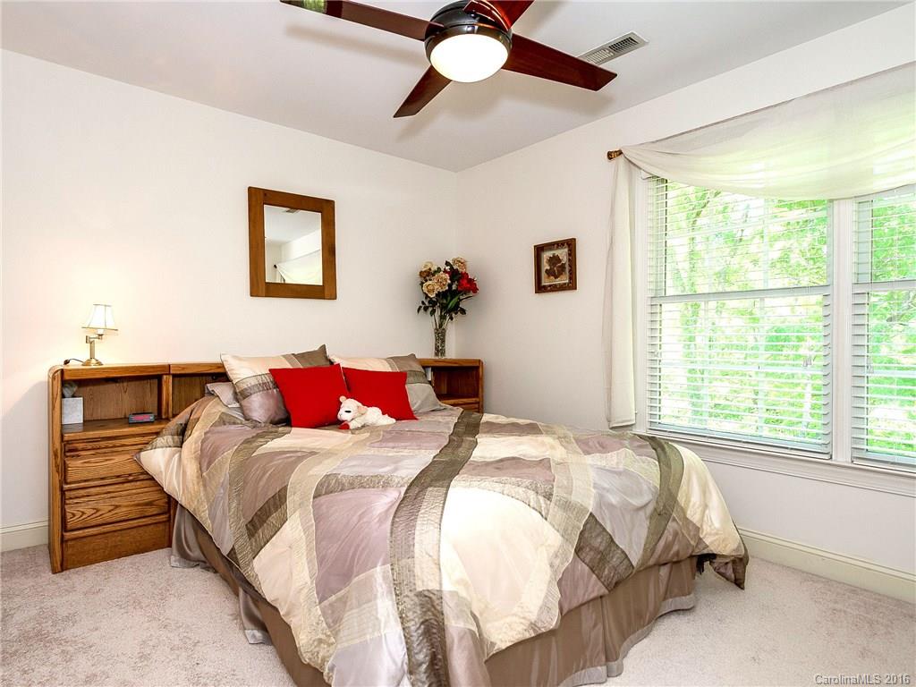 10622 Back Ridge Road Charlotte, NC 28277 - Photo 16 of 24 a bedroom with a bed and a chandelier