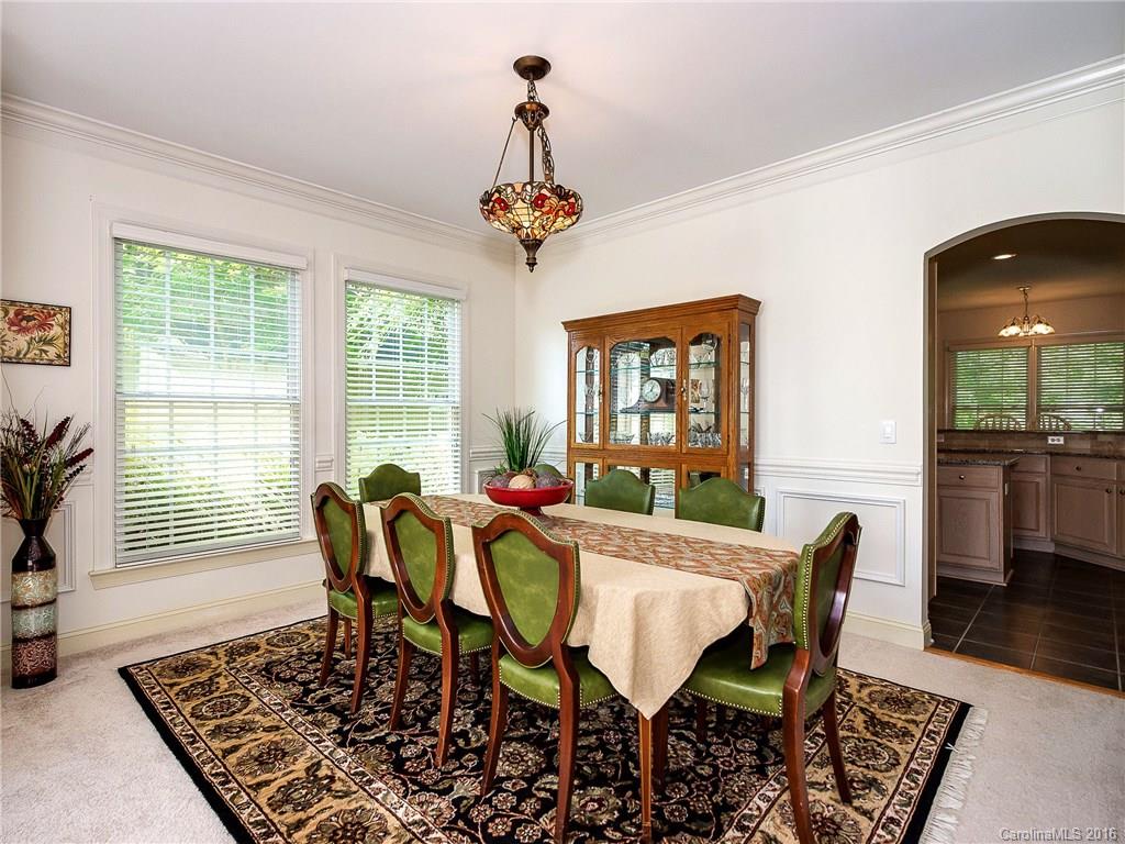 10622 Back Ridge Road Charlotte, NC 28277 - Photo 6 of 24 a dining room with furniture wooden floor a rug and a chandelier