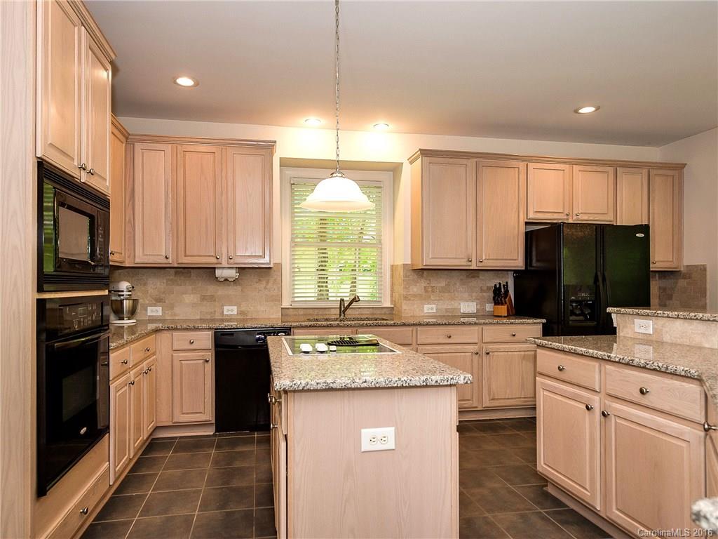 10622 Back Ridge Road Charlotte, NC 28277 - Photo 7 of 24 a kitchen with a sink stove a sink a refrigerator a microwave and cabinets