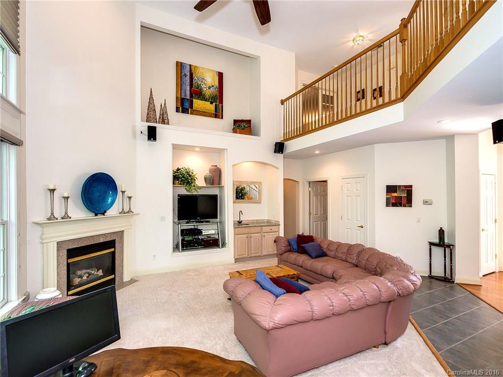10622 Back Ridge Road Charlotte, NC 28277 - Photo 10 of 24 a living room with furniture a flat screen tv and a fireplace