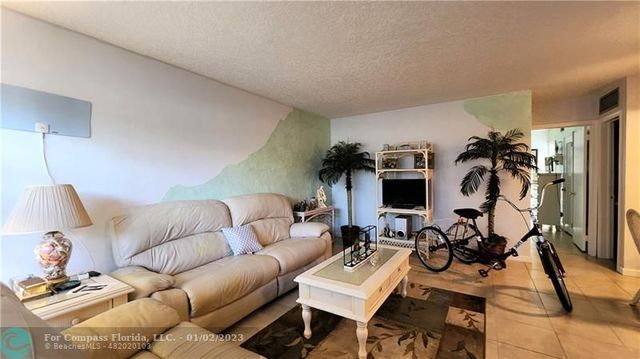 a living room with furniture a view and wooden floor