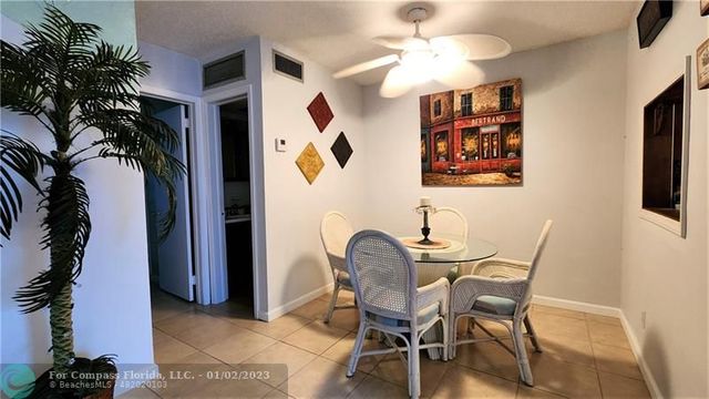 a view of a dining room with furniture and a potted plant