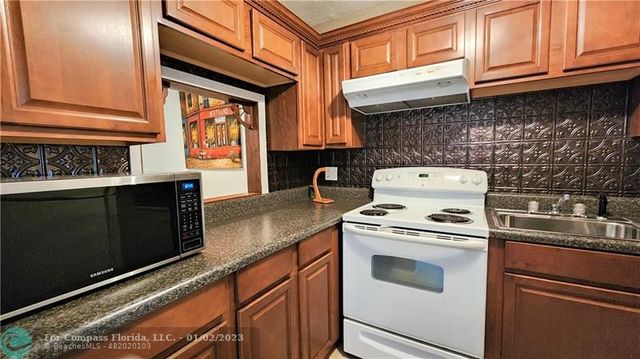a kitchen with a stove and a microwave