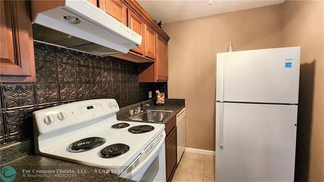 a white refrigerator freezer sitting inside of a kitchen