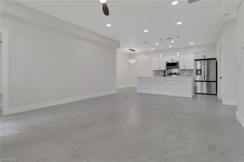 4501-4503 15th Street Southwest Lehigh Acres, FL 33973 - Photo 14 of 50 a view of a kitchen with refrigerator and a stove