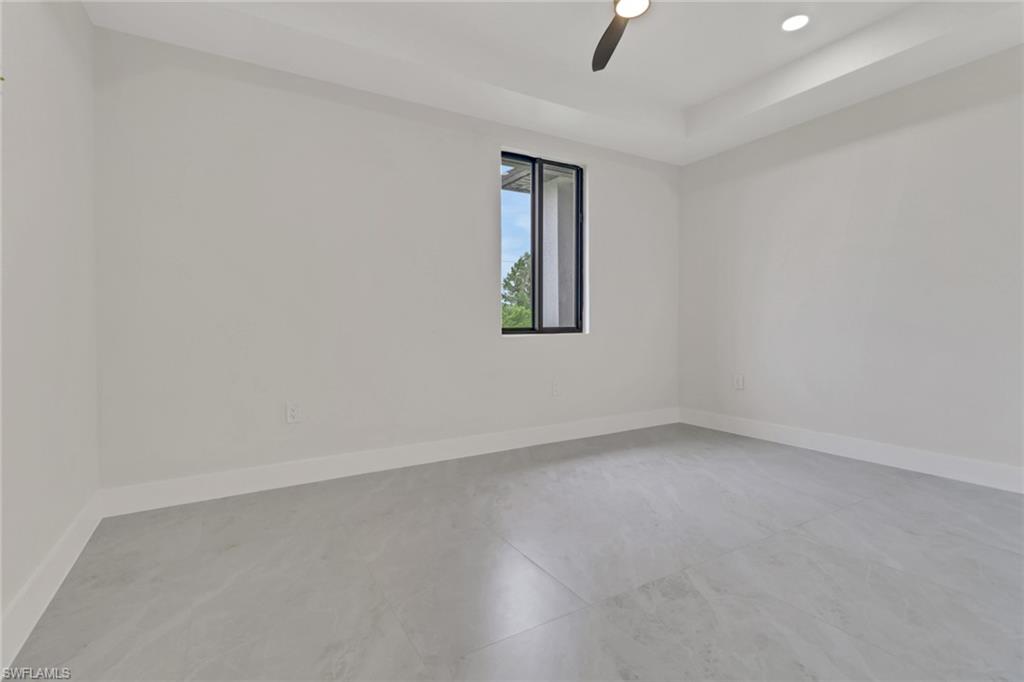 4501-4503 15th Street Southwest Lehigh Acres, FL 33973 - Photo 23 of 50 an empty room with a window and ceiling fan
