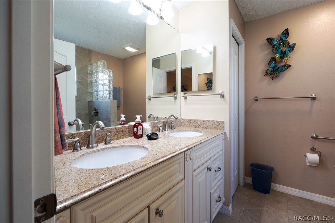 800 Balmoral Court Inverness, FL 34453 - Photo 24 of 72 a en suite bathroom with a granite countertop sink and a mirror
