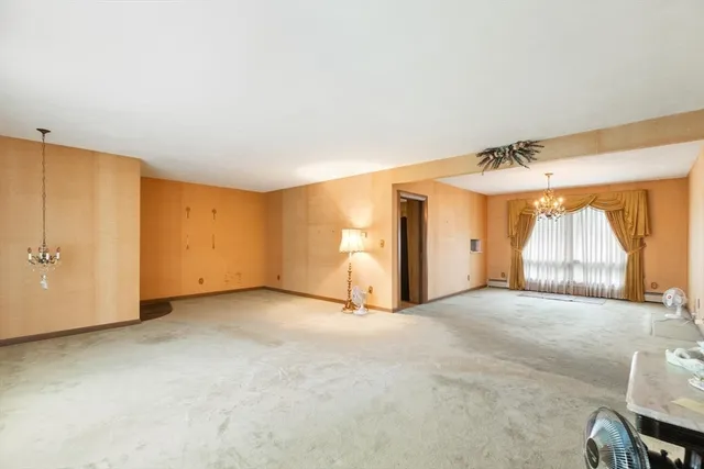 an empty room with a window and a ceiling fan