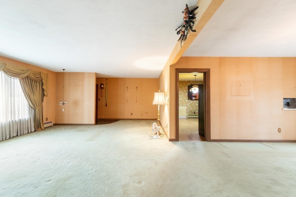 4 R Forest Street Peabody, MA 01960 - Photo 14 of 33 an empty room with a window and a ceiling fan
