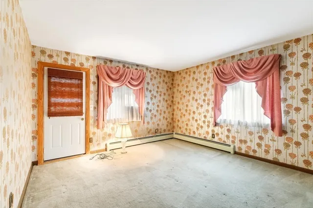 a view of a room with rack on the wall and a window