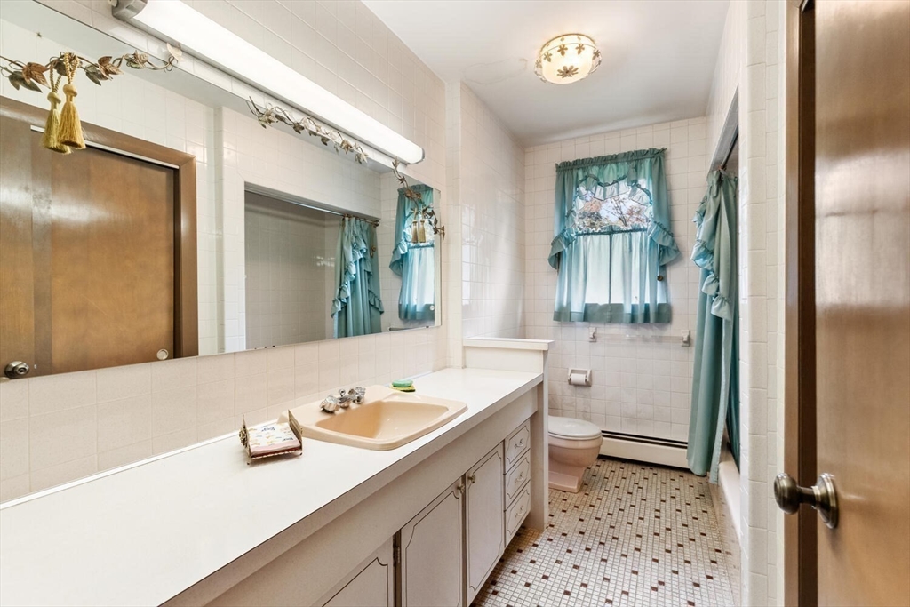 4 R Forest Street Peabody, MA 01960 - Photo 26 of 33 a bathroom with a sink a toilet and shower