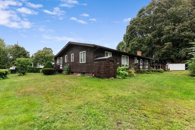 a front view of a house with a garden