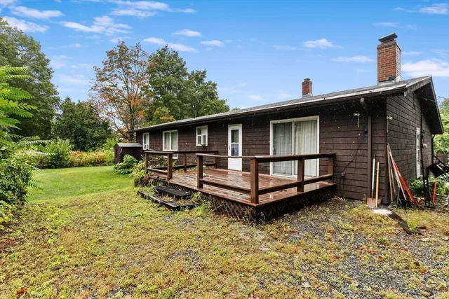 a front view of a house with a yard balcony