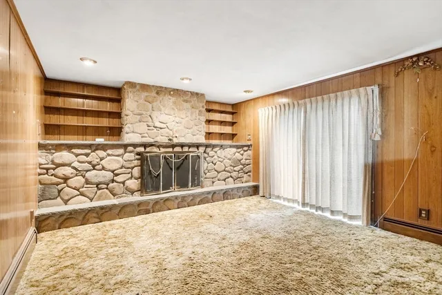 a view of a livingroom with wooden floor and a bathroom