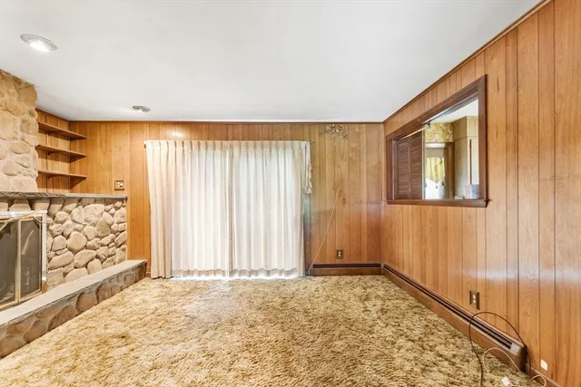 a kitchen with a refrigerator a sink dishwasher with a fireplace and wooden floor