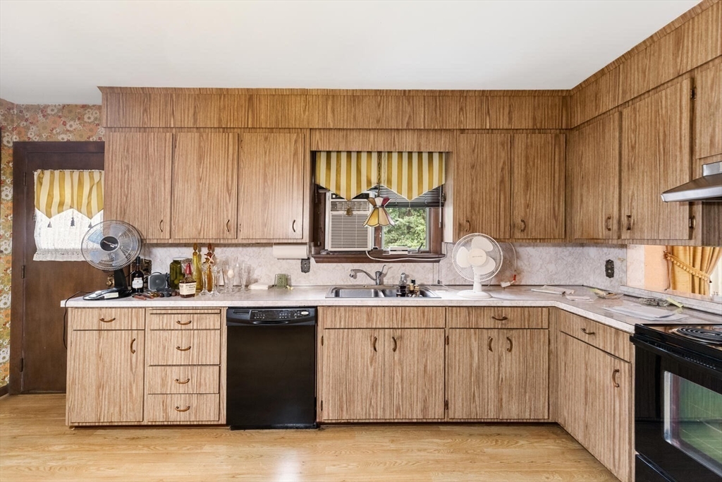 4 R Forest Street Peabody, MA 01960 - Photo 9 of 33 a kitchen with a sink stove and cabinets