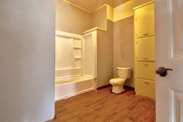 a view of kitchen with wooden floor and white cabinet
