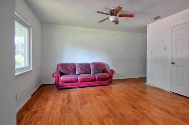 a bathroom with a toilet a sink and a window
