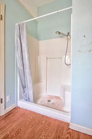 a bathroom with a granite countertop sink mirror vanity and toilet