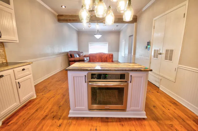 a view of a room with wooden floor and cabinet
