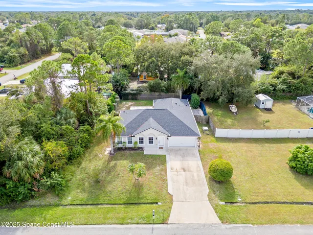 an aerial view of residential houses with yard