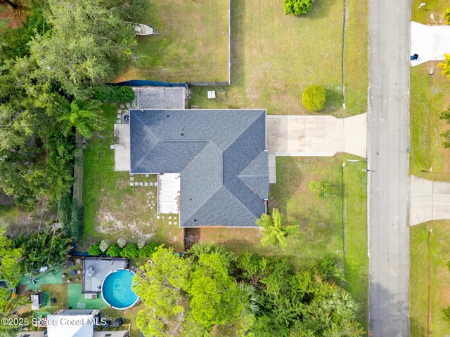 an aerial view of a house with a yard