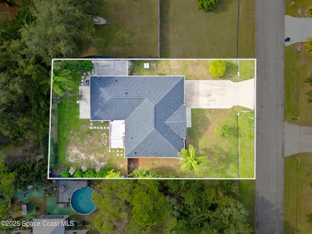 an aerial view of a house with a yard