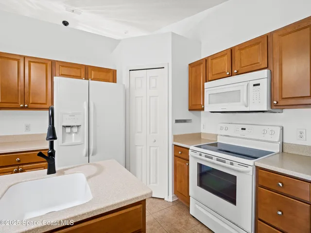 a kitchen with stainless steel appliances a stove cabinets and a sink